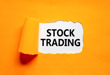 Stock trading symbol. Concept words Stock trading on beautiful white paper. Beautiful orange paper background. Business stock trading concept. Copy space.