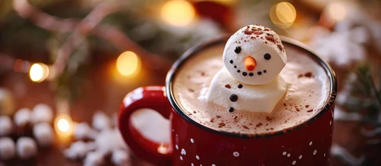 Fotobehang Hot chocolate served in a red mug with a marshmallow snowman. © TheWaterMeloonProjec