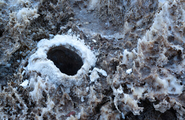 Death Valley National Park, Salt with clay, California. Smooth salt valley with cracked and swollen...