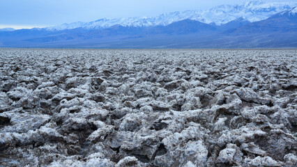 Death Valley National Park, Salt with clay, California. Smooth salt valley with cracked and swollen...
