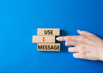 Use I message symbol. Concept word Use I message on wooden blocks. Businessman hand. Beautiful blue background. Business and Use I message concept. Copy space.