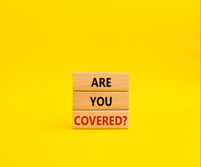 Are you covered symbol. Concept words Are you covered on wooden blocks. Beautiful yellow background. Business and Are you covered concept. Copy space.