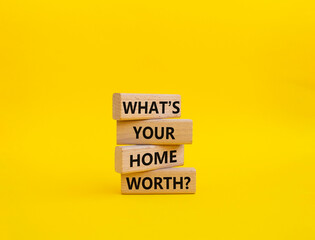 What is your home worth symbol. Wooden blocks with words What is your home worth. Beautiful yellow...