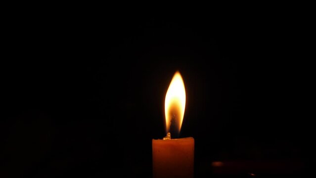 Close candle flame in the dark 4k