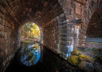 Under an old tunnel with water reflection