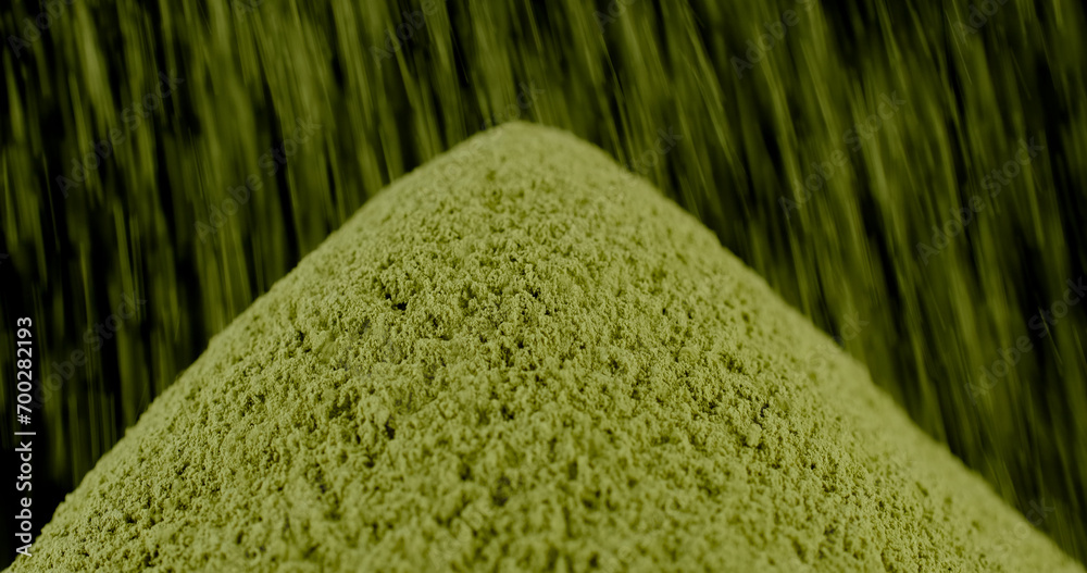 Wall mural sprinkle green powder matcha or spirulina powder on heap, isolated on black background - Wall murals