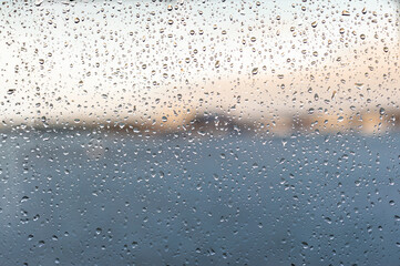 Raindrops on a window pane. Background of raindrops.