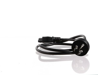 Naklejka premium Black electrical plug with pins and cable on a white background.