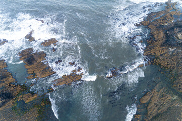 rocky coastline seen from a drone, top view