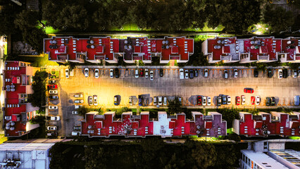 Topdown view of a condominium with parking lot at night