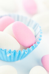 Traditional Easter Portuguese candies. Colorful Sweets in a blue paper cup on a white background