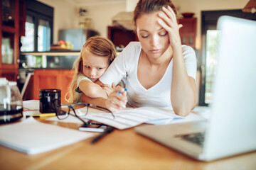 Stressed Mother Working from Home with Child