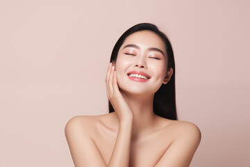 Beautiful happy young Asian woman touching her face caring for facial skin. Skincare concept