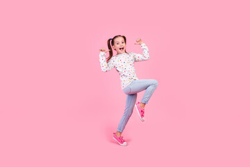 Full size photo of overjoyed nice schoolgirl dressed dotted pullover denim pants directing at herself isolated on pink color background