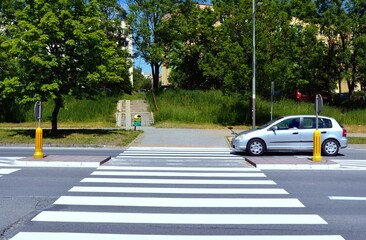 The car passes the pedestrian crossing with road from pedestrian refuge island - obrazy, fototapety, plakaty