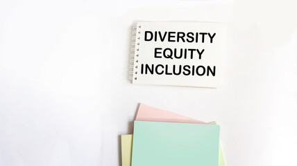 Diversity, equity, inclusion DEI symbol. On the notepad are the words DEI, diversity, equity,...