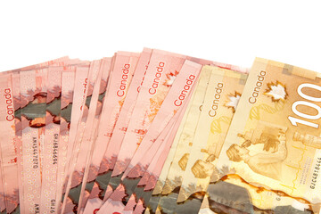 A stack of candian bills of different denomination on a white background.  Synonymous with wealth...