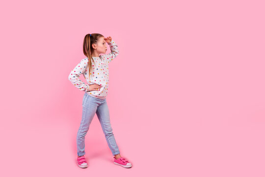 Full size photo of focused schoolgirl dressed dotted pullover palm on forehead look far at empty space isolated on pink color background