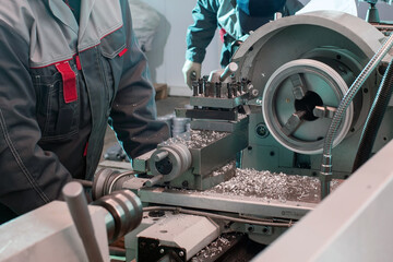 A worker works on a lathe at a machine-building plant.