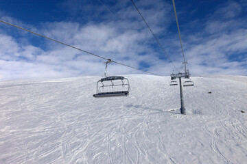 Fototapeta na wymiar Off-piste ski slope and chair-lift on ski resort