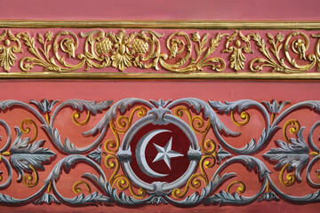 Close-up of decorative wooden ornaments with gilding in the form of an ornament.