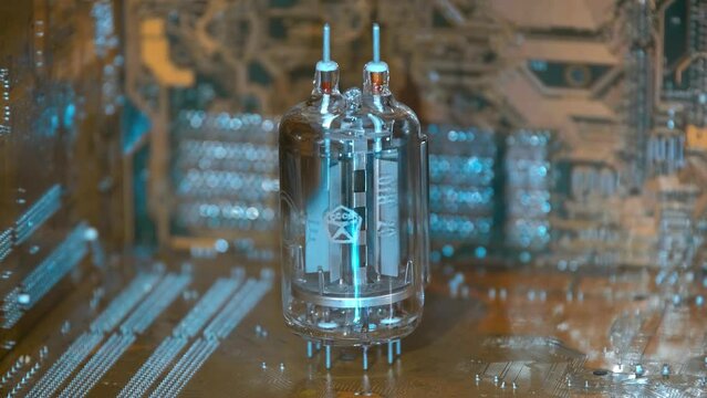 Not a small old Soviet vacuum lamp stands next to modern printed circuit boards, their performance is comparable to millions of similar lamps, as a symbol of old and new technologies. Closeup 