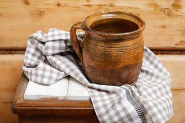 An old ceramic jug in wooden hut.