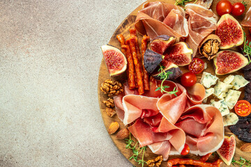 Appetizer from dry cured ham, prosciutto slices with figs and cheese. Dinner or aperitivo party...