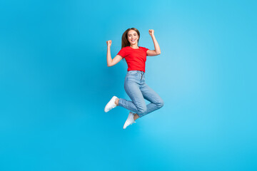 Fototapeta na wymiar Full length photo of charming glad girl dressed trendy red clothes black friday seasonal sale isolated on blue color background