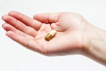 Medical tablet in hand on white background