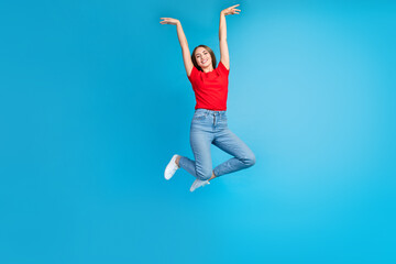 Full length photo of positive glad girl dressed trendy red clothes jumping with raised hands...