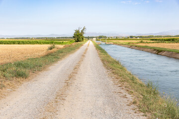 Naklejka premium auxiliary Canal d'Urgell through agricultural fields next to Linyola, comarca of Pla d'Urgell, Province of Lleida, Catalonia, Spain