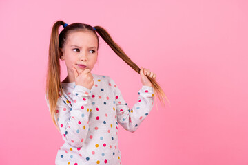 Portrait of pensive schoolgirl with ponytails hairdo dressed dotted sleepwear look empty space hold...