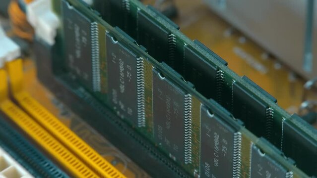 RAM sticks in computer motherboard slots. Closeup. Macro. Shallow depth of field. Shot in motion