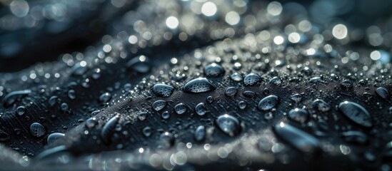 Water droplets on fabric designed to allow breathability. - obrazy, fototapety, plakaty