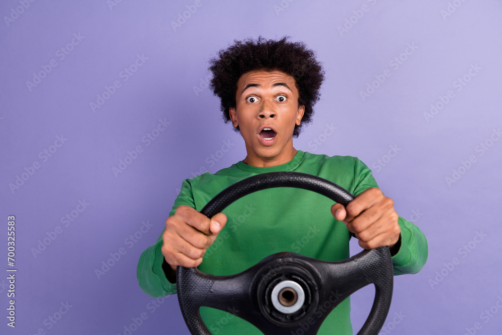 Sticker Photo of shocked amazed man dressed green sweater driving auto open mouth empty space isolated violet color background