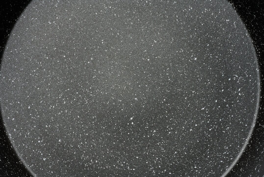 Texture of black non-stick surface of a frying pan