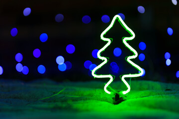 The picture of a little christmas tree made from light pipe, placed on the floor with a very...