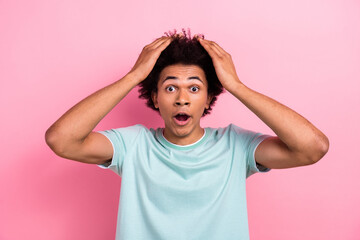 Photo portrait of attractive young man touch head terrible news shocked wear trendy blue clothes isolated on pink color background