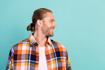 Photo of handsome cheerful man with stubble dressed checkered shirt look at proposition empty space...
