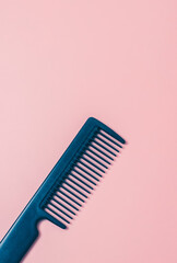 Comb hairdresser on a pink background.