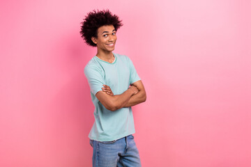 Photo of funky attractive guy wear blue t-shirt arms crossed empty space isolated pink color background
