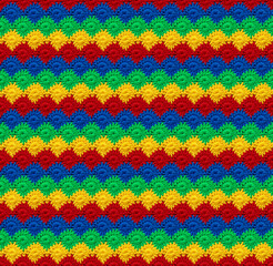 Fototapeta na wymiar Seamless knitted texture in the form of daisies. The pattern is crocheted from multicolored cotton yarn. RGB colors.