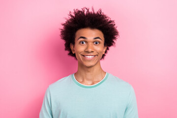 Photo of cheerful positive guy wear blue t-shirt smiling showing white teeth isolated pink color background