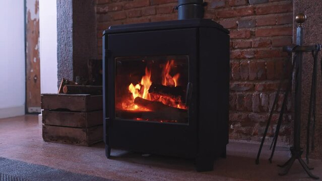 Log burner interior fireplace, warm cosy winter interior fire, wood fire burning, rustic heating