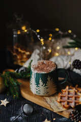 Cocoa in a green cup with chocolate and waffles