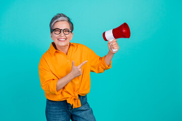 Photo of grandmother hold bullhorn direct finger new loudspeaker as tool for motivation employees isolated on cyan color background