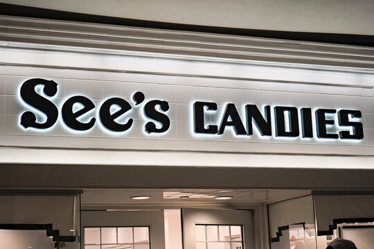 Honolulu, HI - December 23, 2023 : Warren Buffet Birkshire Hathaway owned subsidiary, See's Candies Shops, Inc. candy and chocolate manufacturer's signage at storefront in Ala Moana mall.