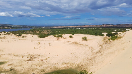 Wind turbines offshore wind projects near large lake and white sand dunes hills at Bau Trang, Bac Binh District, Binh Thuan Province, Vietnam, scenic desert-like landscape travel destination