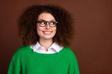 Photo of positive nice creative girl toothy smile look interested empty space brainstorming isolated on brown color background